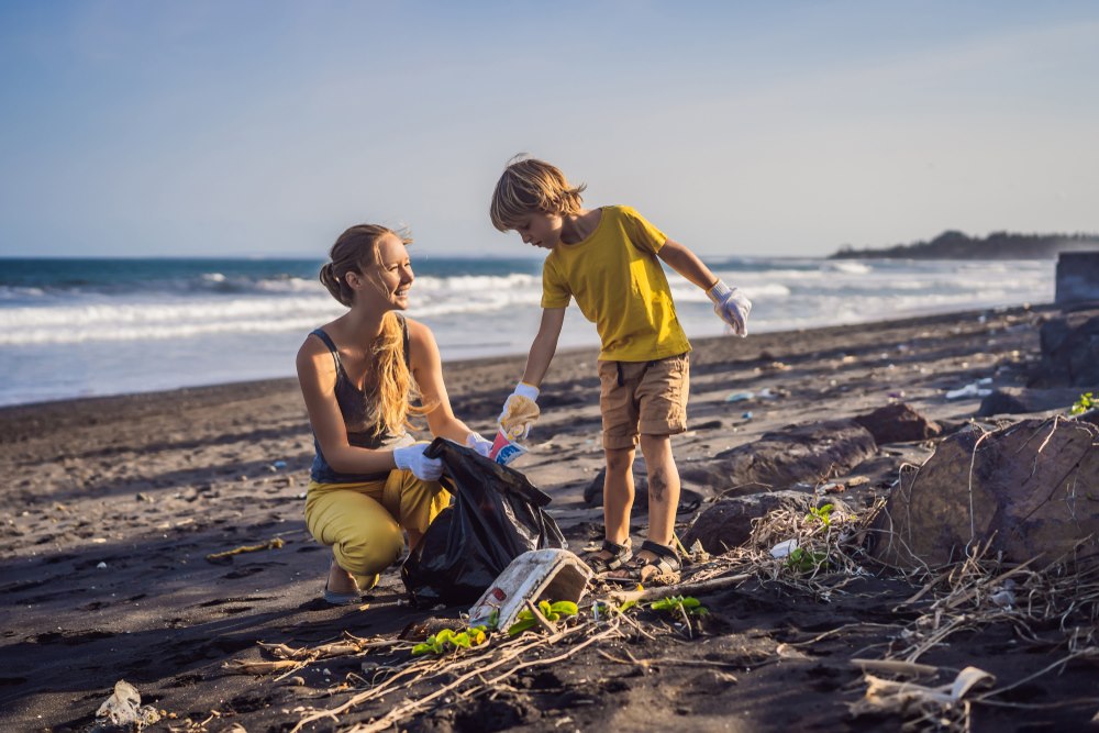 madre e hijo recolectando residuos plásticos en la playa